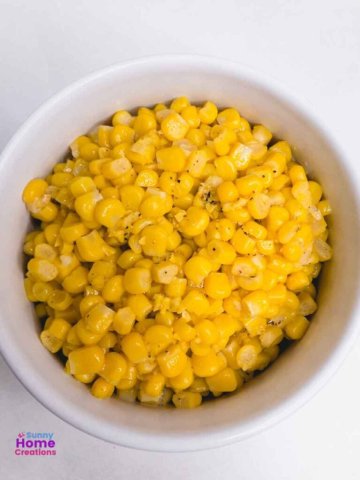 top down view of cooked canned corn in a bowl.