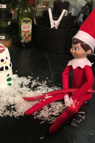 Elf on the Shelf building a snowman.