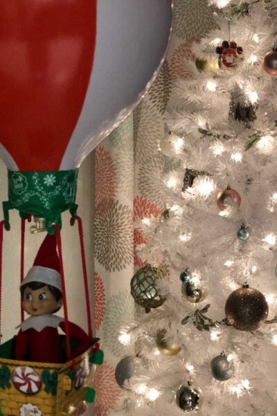 Elf on the Shelf in the basket of a hot air balloon.