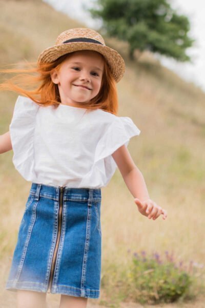 red headed girl on hill.